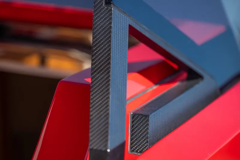 Slide: The Image of Close-up of 2021 Wally 48 yacht's sleek, modern carbon fiber and red design elements. - 35