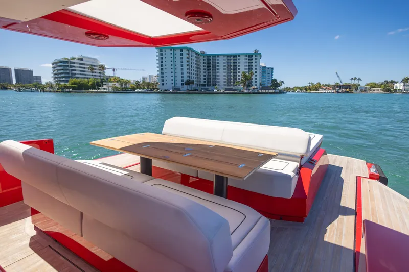 Slide: The Image of Luxury seating area on a 2021 Wally 48 yacht, overlooking a scenic waterfront. - 37