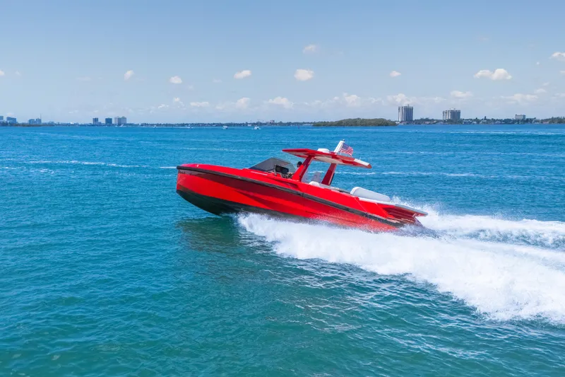 Slide: The Image of Red 2021 Wally 48 yacht cruising on blue ocean waters under clear skies. - 4
