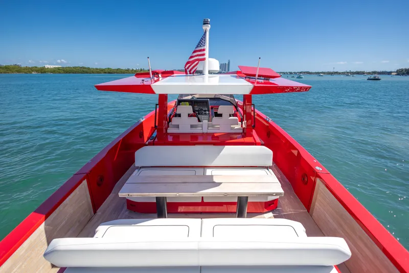 Slide: The Image of Red 2021 Wally 48 yacht with American flag, cruising on clear blue waters. - 40