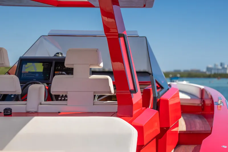 Slide: The Image of Red 2021 Wally 48 yacht interior with modern dashboard and seating, cruising on a sunny day. - 42
