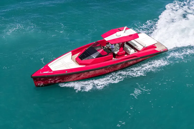 Slide: The Image of Red 2021 Wally 48 yacht cruising on turquoise waters, showcasing sleek design and luxury. - 7