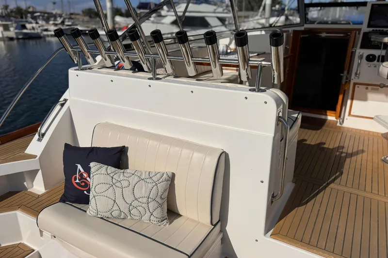 Slide: The Image of 1999 Grand Banks 38 Eastbay EX boat interior with seating and rod holders. - 12