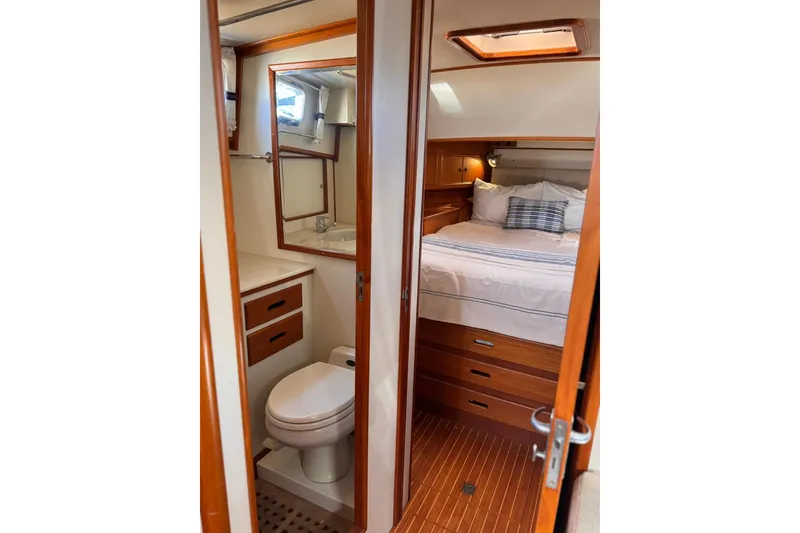 Slide: The Image of 1999 Grand Banks 38 Eastbay EX interior with cozy bedroom and compact bathroom. - 27