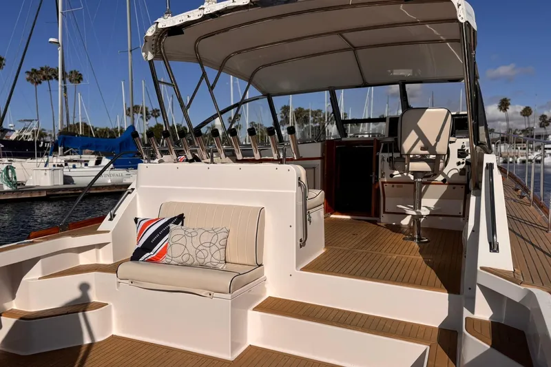 Slide: The Image of 1999 Grand Banks 38 Eastbay EX yacht interior with seating and helm, docked at marina. - 9