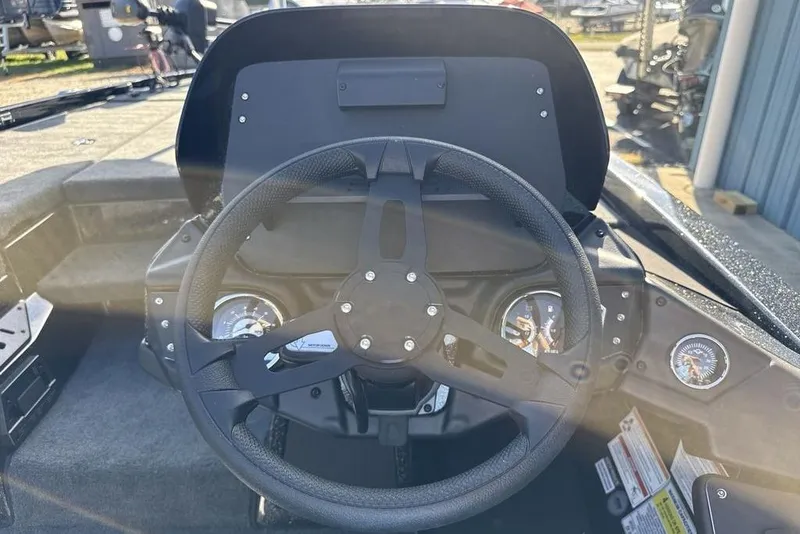 Slide: The Image of 2026 Skeeter ZX200 boat dashboard with steering wheel and gauges in sunlight. - 10