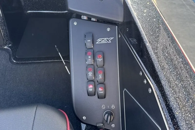 Slide: The Image of Control panel of 2026 Skeeter ZX200 boat with labeled switches and buttons. - 13