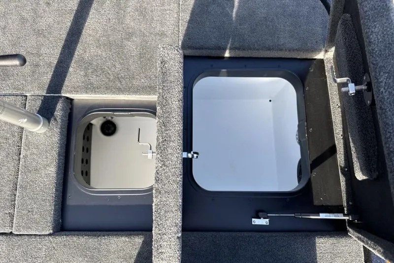 Slide: The Image of Interior storage compartments of a 2026 Skeeter ZX200 boat, featuring carpeted surfaces. - 21