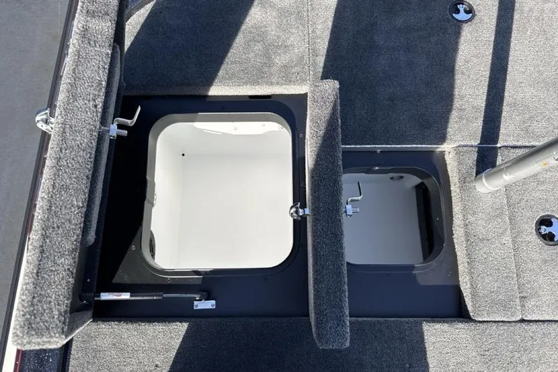 Slide: The Image of 2026 Skeeter ZX200 boat storage compartments with open hatches, showcasing interior space. - 22