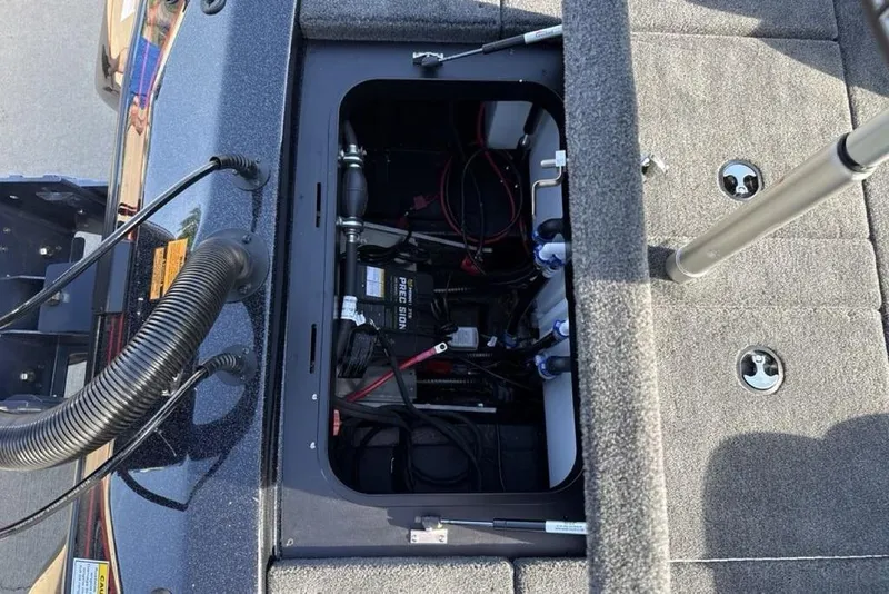 Slide: The Image of 2026 Skeeter ZX200 boat battery compartment with wiring and components visible. - 24