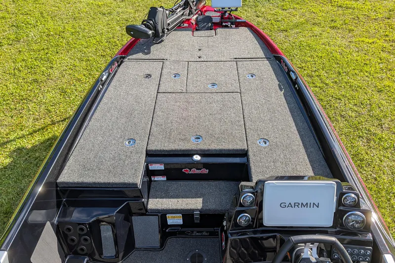 Slide: The Image of 2026 Bass Cat Cougar FTD boat deck with Garmin navigation system, on grassy background. - 11