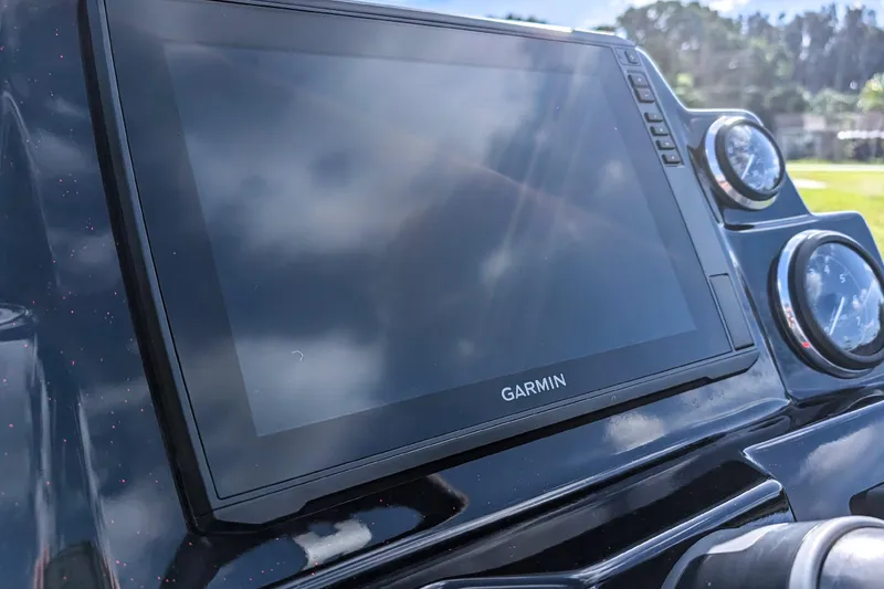 Slide: The Image of Garmin display on 2026 Bass Cat Cougar FTD boat dashboard, sunny day reflection. - 19