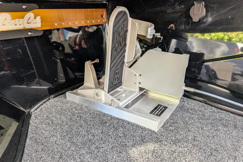 Slide: The Image of 2026 Bass Cat Cougar FTD boat foot pedal on carpeted deck. - 20