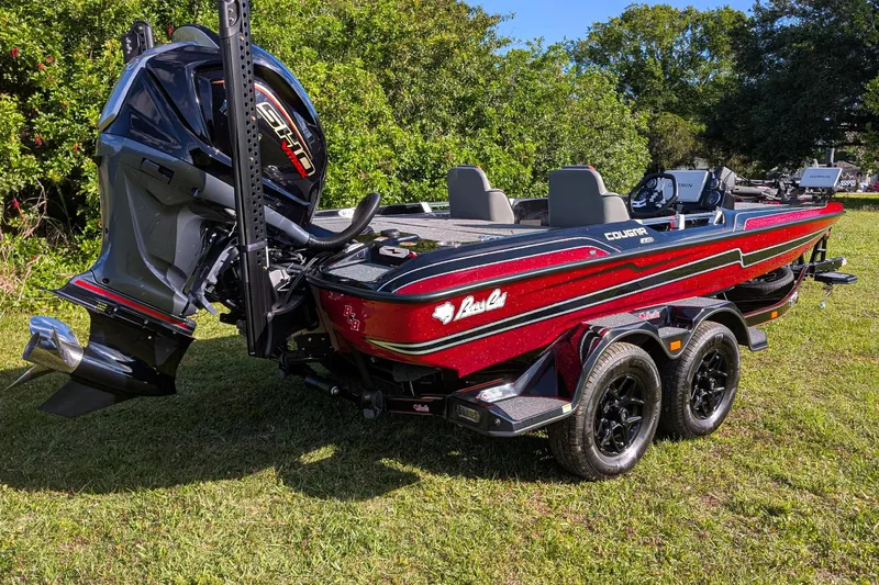 Slide: The Image of 2026 Bass Cat Cougar FTD boat with powerful engine on grassy area. - 6