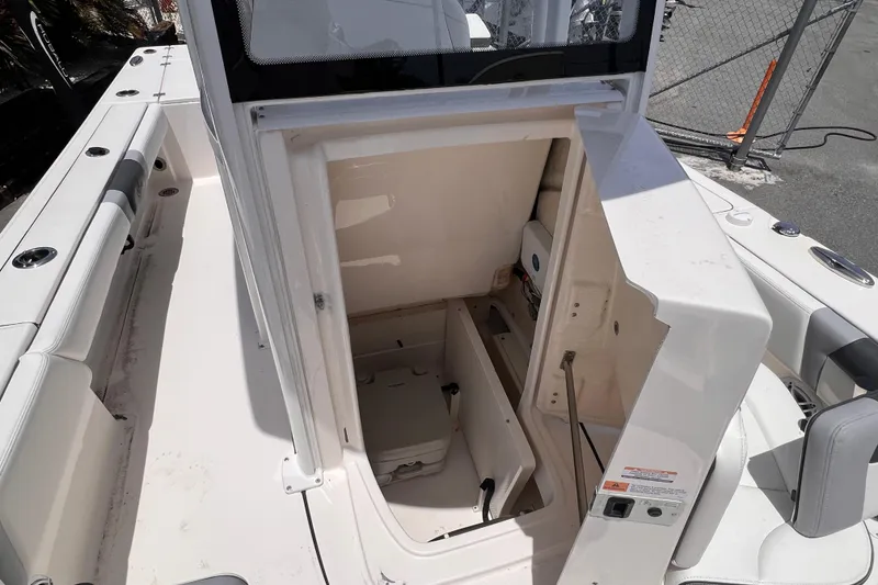 Slide: The Image of 2022 Robalo 246 Cayman boat interior storage compartment, open hatch view. - 10