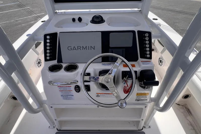 Slide: The Image of 2022 Robalo 246 Cayman boat console with Garmin navigation system and steering wheel. - 12