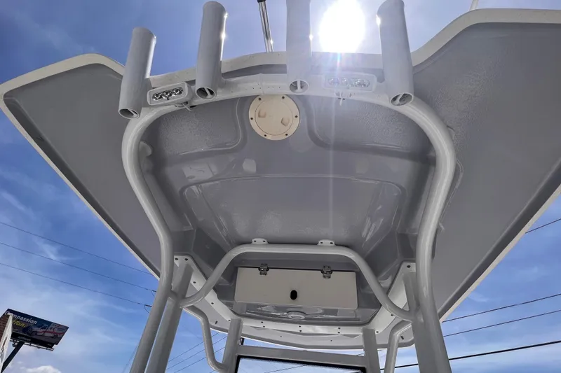 Slide: The Image of 2022 Robalo 246 Cayman boat T-top under bright sun and blue sky. - 13