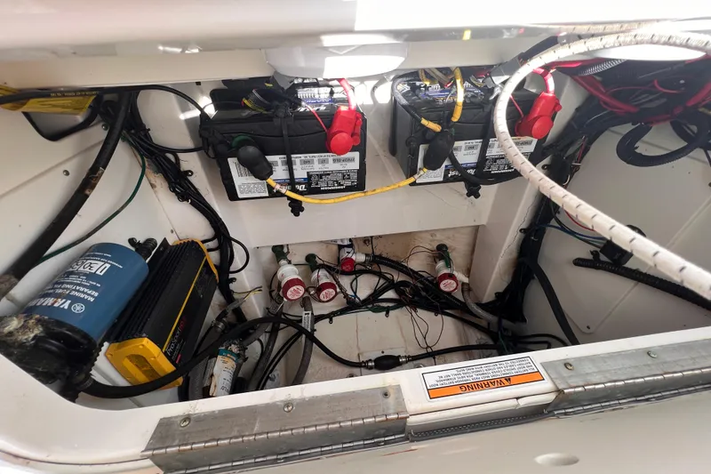 Slide: The Image of 2022 Robalo 246 Cayman boat battery compartment with wiring and components. - 15