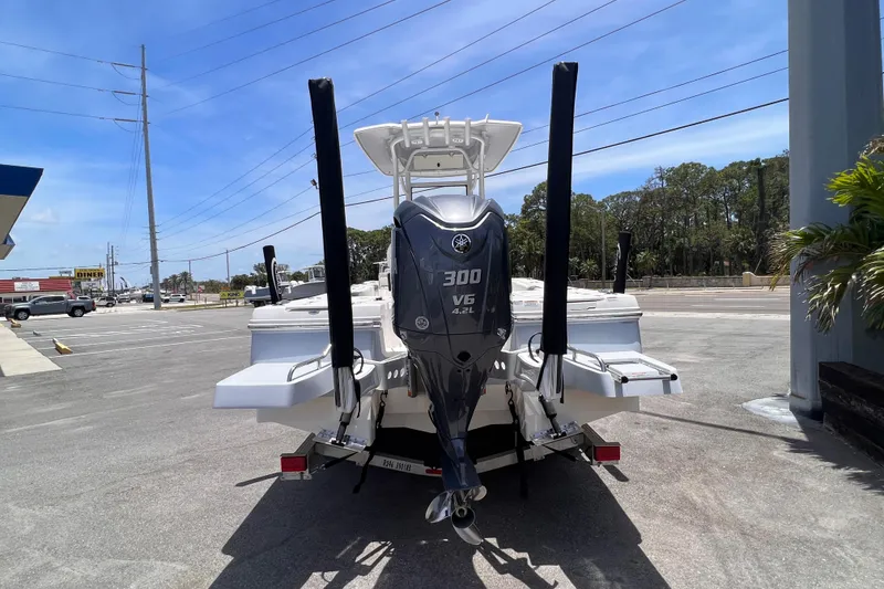 Slide: The Image of 2022 Robalo 246 Cayman boat with Yamaha 300 V6 engine, parked outdoors. - 3