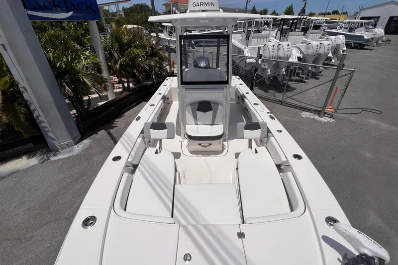 Slide: The Image of 2022 Robalo 246 Cayman boat with Garmin equipment, docked at a marina. - 4