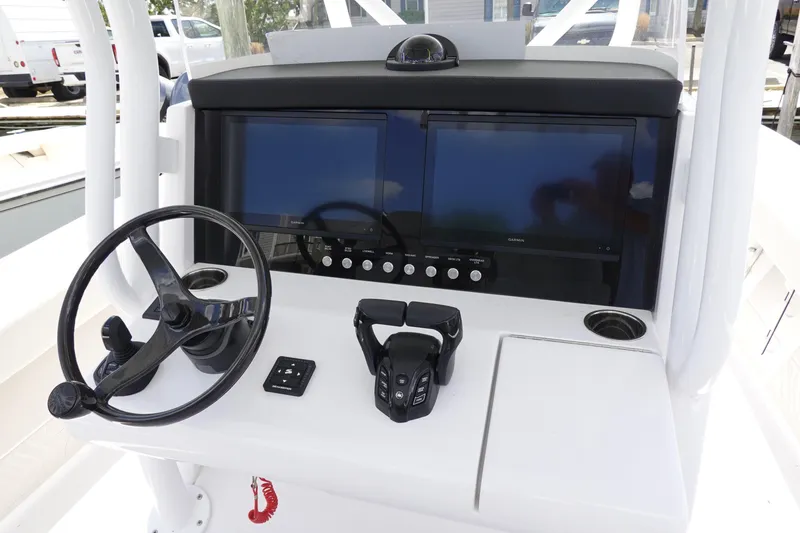 Slide: The Image of 2026 Jupiter 32 FS boat dashboard with dual screens and steering wheel. - 10