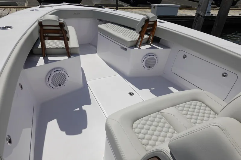 Slide: The Image of Luxurious seating area on a 2026 Jupiter 32 FS boat, featuring modern design and speakers. - 14