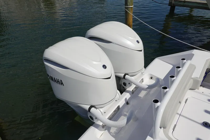 Slide: The Image of Twin Yamaha outboard engines on a 2026 Jupiter 32 FS boat, docked on calm water. - 3