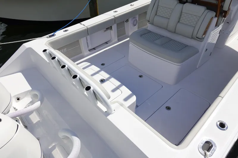 Slide: The Image of 2026 Jupiter 32 FS boat interior with seating and rod holders, showcasing sleek design and functionality. - 4