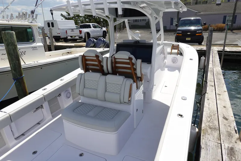 Slide: The Image of 2026 Jupiter 32 FS boat interior with cushioned seating at a marina dock. - 5