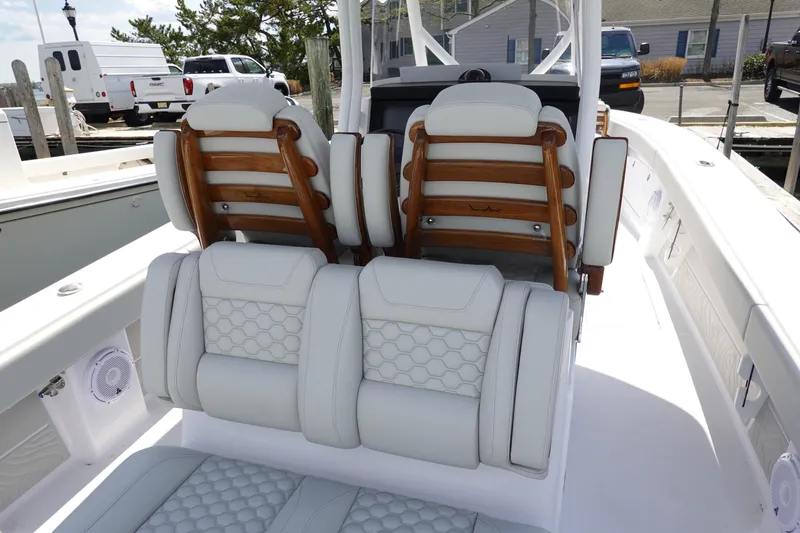Slide: The Image of 2026 Jupiter 32 FS boat interior with luxurious white seating and wooden accents. - 9
