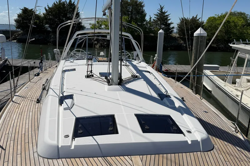 Slide: The Image of 2016 Beneteau Oceanis 48 sailboat docked, showcasing sleek deck design and modern features. - 11