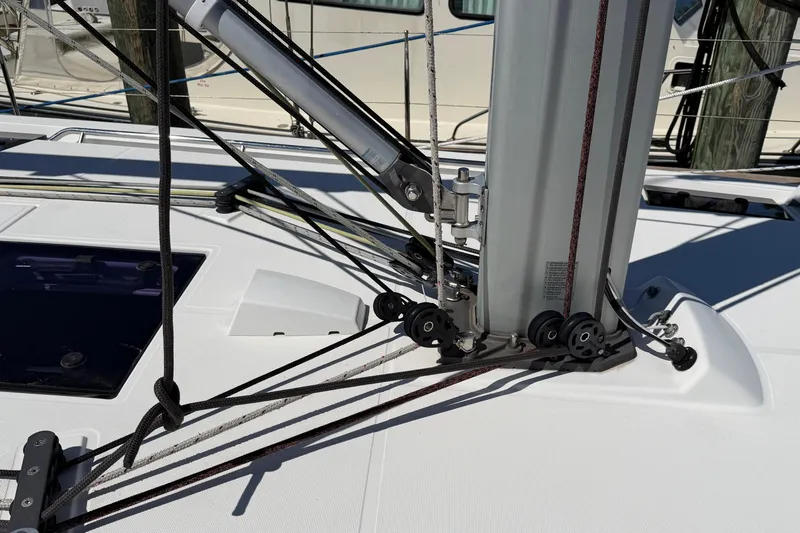 Slide: The Image of Deck rigging of a 2016 Beneteau Oceanis 48 sailboat, featuring ropes and pulleys. - 12