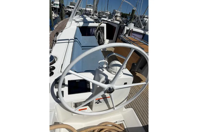 Slide: The Image of 2016 Beneteau Oceanis 48 yacht cockpit with steering wheel and navigation equipment. - 14