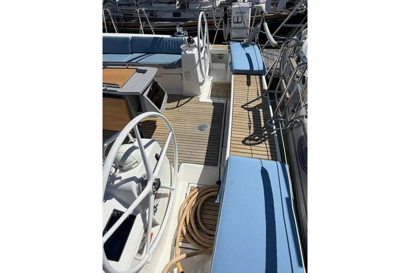Slide: The Image of 2016 Beneteau Oceanis 48 yacht cockpit with dual steering wheels and teak decking. - 15