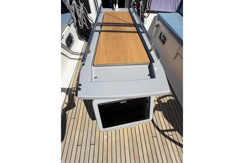 Slide: The Image of Beneteau Oceanis 48 (2016) cockpit with teak flooring and navigation equipment. - 16