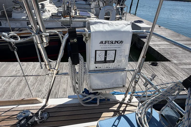 Slide: The Image of Beneteau Oceanis 48 (2016) with Lifesling rescue system on deck by marina. - 19