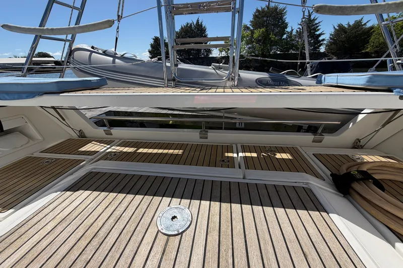 Slide: The Image of 2016 Beneteau Oceanis 48 yacht deck with wooden flooring and ladder. - 20
