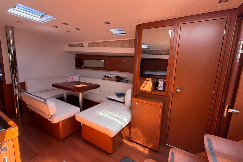 Slide: The Image of Interior of 2016 Beneteau Oceanis 48 yacht with elegant wood finish and cozy seating area. - 25