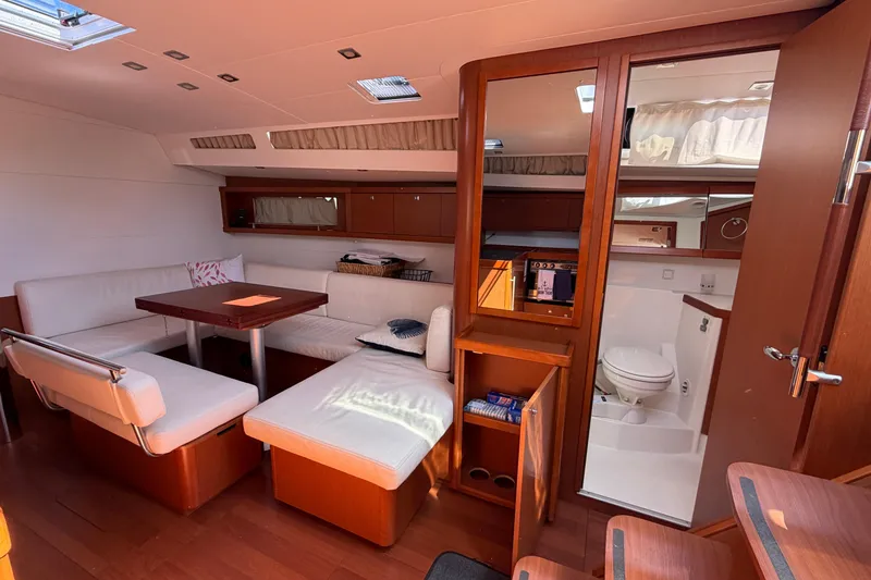 Slide: The Image of Interior of 2016 Beneteau Oceanis 48 yacht with cozy seating and modern amenities. - 26