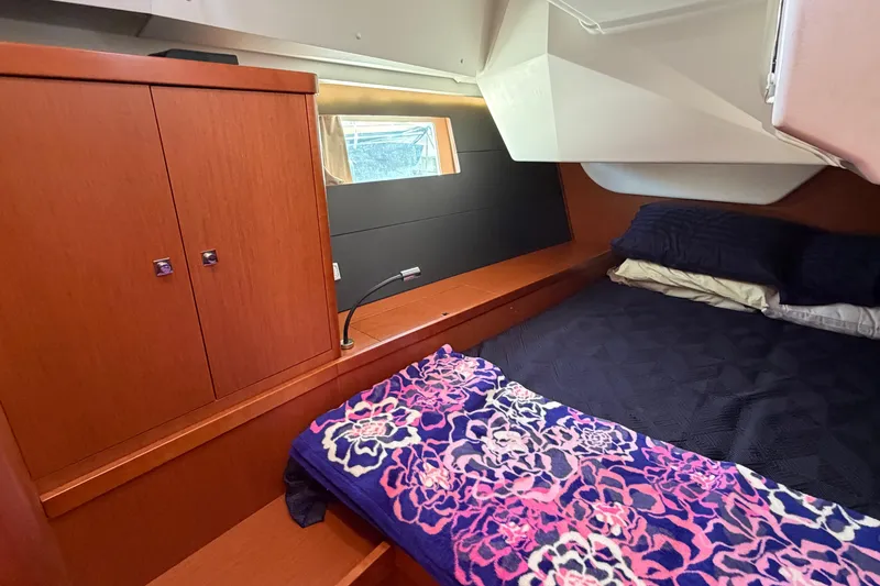 Slide: The Image of Cozy cabin interior of 2016 Beneteau Oceanis 48 yacht with wooden cabinetry and bed. - 31