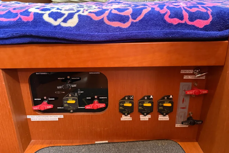 Slide: The Image of Control panel of a 2016 Beneteau Oceanis 48 sailboat with battery switches and breakers. - 32