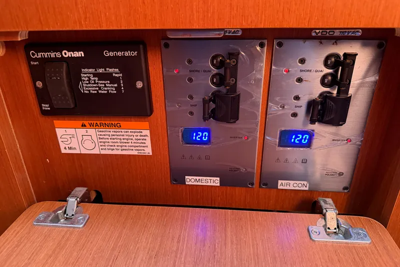 Slide: The Image of Control panel of a 2016 Beneteau Oceanis 48 sailboat with generator and electrical switches. - 35
