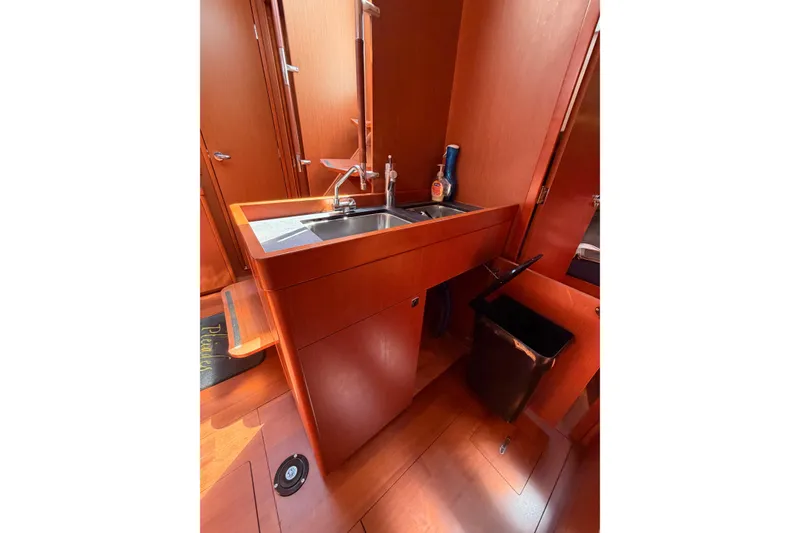 Slide: The Image of Interior of 2016 Beneteau Oceanis 48 yacht featuring a sleek wooden sink area. - 37