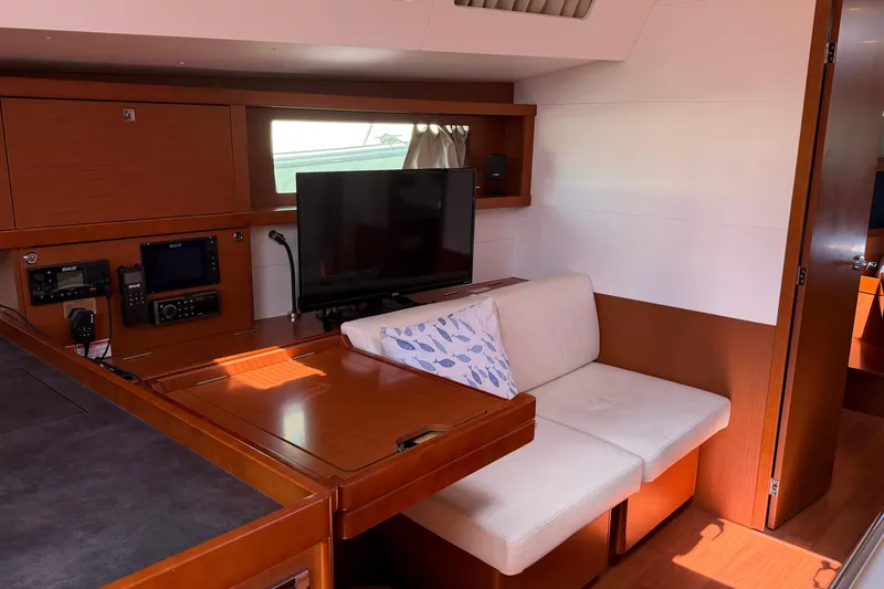 Slide: The Image of Interior of 2016 Beneteau Oceanis 48 yacht with cozy seating and modern navigation equipment. - 39