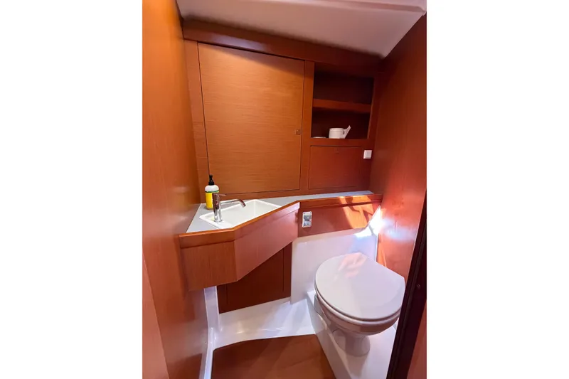 Slide: The Image of 2016 Beneteau Oceanis 48 yacht bathroom with wooden cabinetry and modern fixtures. - 45