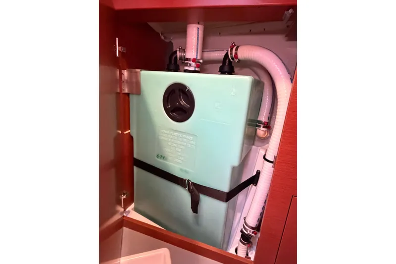 Slide: The Image of Water tank system inside a 2016 Beneteau Oceanis 48 yacht, featuring secure piping and fittings. - 46