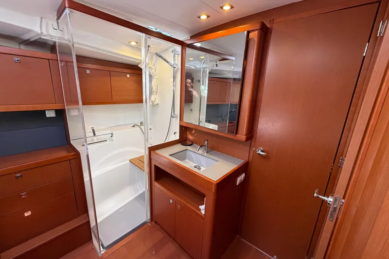 Slide: The Image of Luxurious bathroom interior of 2016 Beneteau Oceanis 48 yacht with wooden cabinetry. - 47
