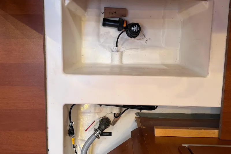 Slide: The Image of Interior view of a 2016 Beneteau Oceanis 48 yacht showing storage compartment and plumbing. - 49