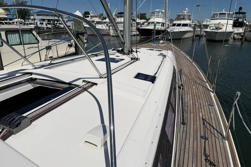 Slide: The Image of 2016 Beneteau Oceanis 48 sailboat docked at marina, showcasing sleek deck design. - 5