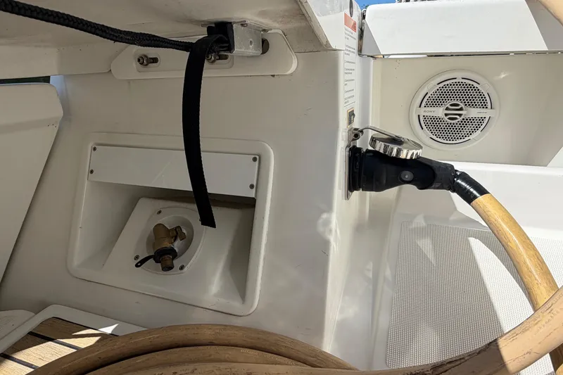 Slide: The Image of 2016 Beneteau Oceanis 48 yacht cockpit with hose connection and speaker. - 52